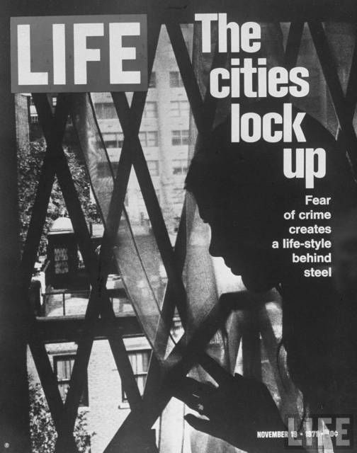 "LIFE reporter Karen Thorsen peering through window gates of East Side apartment after it was burglarized."